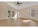 Bright living room with hardwood floors, vaulted ceiling, and backyard views at 10621 Golden Cypress Ct, Orlando, FL 32836