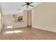 Open living room with hardwood floors, ceiling fan, and plenty of natural light at 10621 Golden Cypress Ct, Orlando, FL 32836