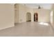 Bright open space with tile flooring, neutral tones, and an open archway leading to the kitchen area at 10621 Golden Cypress Ct, Orlando, FL 32836