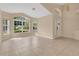 Spacious open-concept living room with tile flooring, large windows, and neutral colors, enhancing its appeal at 10621 Golden Cypress Ct, Orlando, FL 32836
