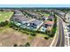 An aerial view of the modern home, surrounded by community landscaping and a nearby golf course at 1080 E Jack Nicklaus Ct, Kissimmee, FL 34747