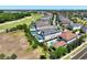 Aerial view of the home, showcasing a swimming pool, landscaping, and access to a golf course at 1080 E Jack Nicklaus Ct, Kissimmee, FL 34747