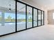 View of backyard pool, patio, and summer kitchen from living room at 1080 E Jack Nicklaus Ct, Kissimmee, FL 34747