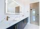 Modern bathroom with double sink vanity, illuminated mirror, and glass-enclosed shower at 1080 E Jack Nicklaus Ct, Kissimmee, FL 34747