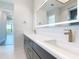 Bathroom featuring dual sinks, illuminated mirror, and designer fixtures at 1080 E Jack Nicklaus Ct, Kissimmee, FL 34747