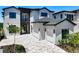 Beautiful two-story home with a brick driveway, three car garage, and landscaped yard at 1080 E Jack Nicklaus Ct, Kissimmee, FL 34747