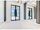 Entrance hall with tile floors, designer lighting, and large mirrors creating a stylish and open area at 1080 E Jack Nicklaus Ct, Kissimmee, FL 34747