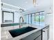 Open-concept kitchen featuring a kitchen island, seamless flow to the outdoor pool area and modern fireplace at 1080 E Jack Nicklaus Ct, Kissimmee, FL 34747