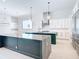 Spacious kitchen showcasing an island with countertop, modern appliances, and sleek white cabinetry at 1080 E Jack Nicklaus Ct, Kissimmee, FL 34747