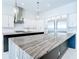 Modern kitchen with marble countertop island, stainless steel appliances and elegant pendant lighting at 1080 E Jack Nicklaus Ct, Kissimmee, FL 34747