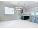 Open kitchen boasts white cabinetry, stainless appliances, two islands and modern pendant lighting at 1080 E Jack Nicklaus Ct, Kissimmee, FL 34747