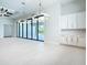 Spacious living room with modern lighting and large sliding doors leading to an outdoor pool at 1080 E Jack Nicklaus Ct, Kissimmee, FL 34747
