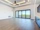 Bright living room with hardwood floors, custom ceiling, and sliding glass doors leading to the balcony at 1080 E Jack Nicklaus Ct, Kissimmee, FL 34747