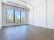 Bright living room with dark wood floors, modern chandelier, and large window with scenic view at 1080 E Jack Nicklaus Ct, Kissimmee, FL 34747