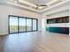 Bright living room with high ceiling, custom cabinets, and sliding glass doors to the balcony at 1080 E Jack Nicklaus Ct, Kissimmee, FL 34747
