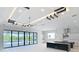 Open living area featuring modern ceiling accents, access to the patio and kitchen at 1080 E Jack Nicklaus Ct, Kissimmee, FL 34747