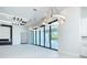 Spacious living room with modern lighting, glass sliding doors, and pool views at 1080 E Jack Nicklaus Ct, Kissimmee, FL 34747