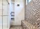 Luxurious shower with glass door, built-in shelves, and decorative tile accents at 1080 E Jack Nicklaus Ct, Kissimmee, FL 34747