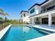A large, pristine swimming pool and spa, perfect for outdoor entertaining, in the backyard at 1080 E Jack Nicklaus Ct, Kissimmee, FL 34747