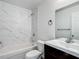 Updated bathroom with modern vanity, tiled shower, and bathtub at 12388 Se 106Th Ave, Belleview, FL 34420