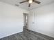 Bedroom featuring wood-look floors, ceiling fan, and closet at 12388 Se 106Th Ave, Belleview, FL 34420