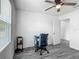 Bedroom featuring wood-look floors, ceiling fan, and modern desk setup at 12388 Se 106Th Ave, Belleview, FL 34420