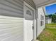 Close-up of the front door on this home with gray siding at 12388 Se 106Th Ave, Belleview, FL 34420