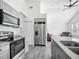 Modern kitchen features stainless steel appliances, granite countertops, and luxury vinyl plank flooring at 12388 Se 106Th Ave, Belleview, FL 34420