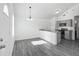 Modern kitchen features granite countertops, stainless steel appliances, and an open layout with a view of the dining area at 12388 Se 106Th Ave, Belleview, FL 34420