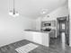 Bright living room with luxury vinyl plank flooring and modern open floor plan with updated kitchen at 12388 Se 106Th Ave, Belleview, FL 34420