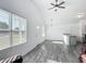 Bright living room with luxury vinyl plank flooring, ceiling fan, and a modern open floor plan at 12388 Se 106Th Ave, Belleview, FL 34420