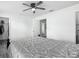 The bedroom has a ceiling fan, luxury vinyl plank flooring, and a walk-in closet at 12388 Se 106Th Ave, Belleview, FL 34420