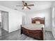 The bedroom has a ceiling fan, luxury vinyl plank flooring, and an en suite bathroom at 12388 Se 106Th Ave, Belleview, FL 34420