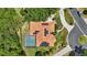 An aerial view shows the property with a private pool and solar panels on the roof at 128 Lake Region Cir, Winter Haven, FL 33881
