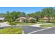 Inviting home with manicured lawn, arched windows, tile roof, and lush landscaping creates great curb appeal at 128 Lake Region Cir, Winter Haven, FL 33881