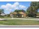 Charming single-story home features a well-manicured lawn, mature landscaping, and beautiful trees at 128 Lake Region Cir, Winter Haven, FL 33881