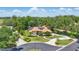 An expansive view shows the beautiful home surrounded by trees at 128 Lake Region Cir, Winter Haven, FL 33881