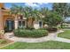 Lovely home entrance featuring well-kept landscaping and a welcoming walkway at 128 Lake Region Cir, Winter Haven, FL 33881