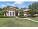 Charming single-story home with a well-manicured lawn and lush landscaping at 128 Lake Region Cir, Winter Haven, FL 33881