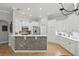 Bright kitchen features white cabinetry, stainless steel appliances, and a mosaic backsplash at 128 Lake Region Cir, Winter Haven, FL 33881