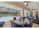 Screened lanai featuring a ceiling fan, outdoor seating, and a view of the pool at 128 Lake Region Cir, Winter Haven, FL 33881