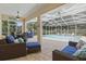 Enclosed lanai with screened in pool, ceiling fan, and outdoor furniture at 128 Lake Region Cir, Winter Haven, FL 33881