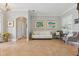 A bright and airy living room with tiled floors, neutral paint, and a comfortable sitting area at 128 Lake Region Cir, Winter Haven, FL 33881