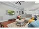 Cozy living room with hardwood floors, sectional couch, and views into the bright kitchen at 128 Lake Region Cir, Winter Haven, FL 33881