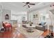 Open-concept living space with hardwood floors, modern furniture, and seamless kitchen access at 128 Lake Region Cir, Winter Haven, FL 33881
