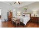 Primary bedroom featuring tray ceiling, wood floor, and decorative accents at 128 Lake Region Cir, Winter Haven, FL 33881