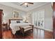 Primary bedroom featuring tray ceiling, wood floor, and door to the lanai at 128 Lake Region Cir, Winter Haven, FL 33881