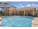Beautiful backyard pool with screened lanai and views of the home's exterior at 128 Lake Region Cir, Winter Haven, FL 33881