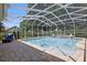 Screened in pool with brick paver decking and peaceful private backyard setting at 128 Lake Region Cir, Winter Haven, FL 33881