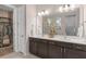 Bathroom with double sink vanity, and an entrance to the walk-in closet at 1302 Nestled Valley Rd, Minneola, FL 34715